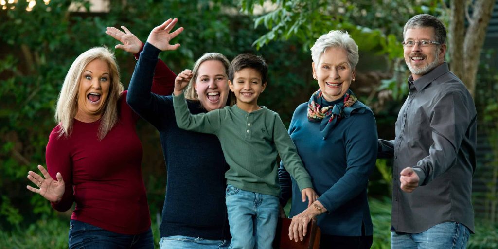 A family horsing around during a portrait session.