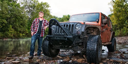 Guy with jeep in a creek-senior pictures Brenham